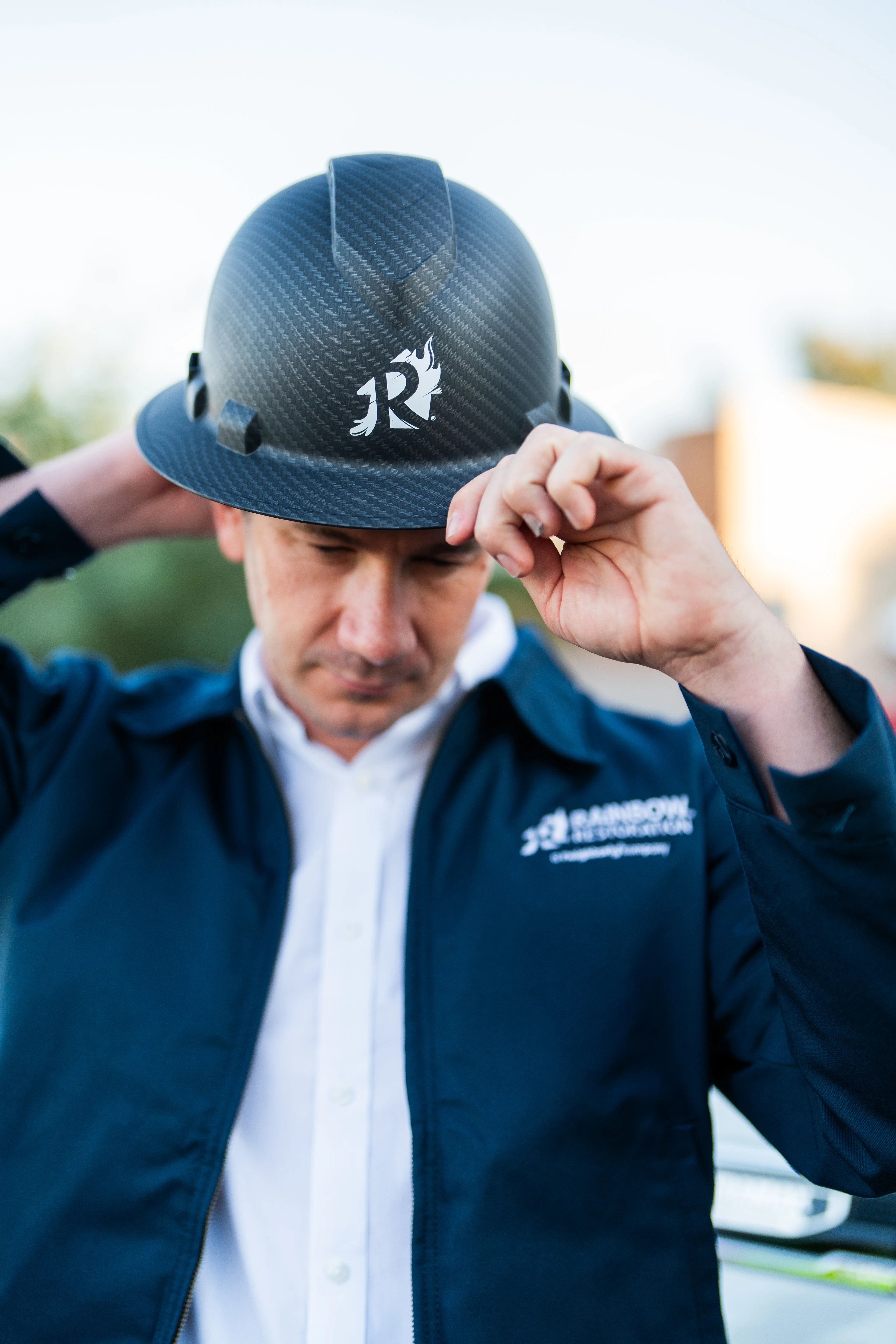water remediation specialist putting on his hat