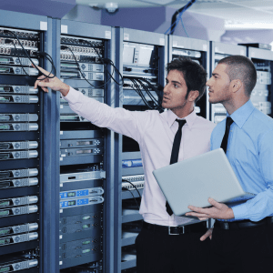Servers in data centre and two men. The environmental impact of data centres, electricity & cooling systems. #environmental #internet #datacentres #globalemissions #environmentalawareness #gogreen #climatechange Servers in data centre and two men.