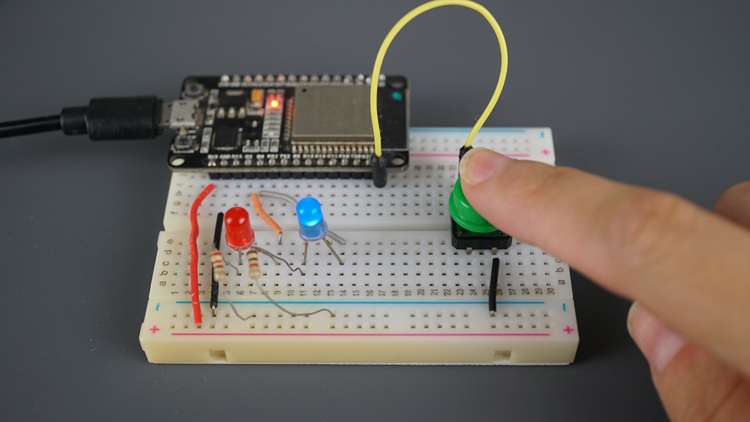 ESP32 with two LEDs and a pushbutton - pushbutton being pressed to toggle the state of an LED
