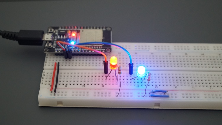 ESP32 connected to two LEDs blinking at different frequencies using software timers