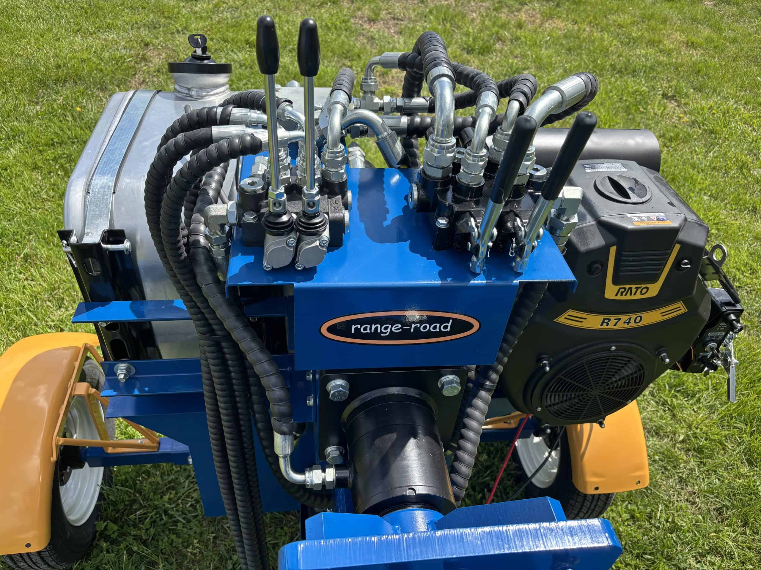 Hydraulic pump with multiple hoses and controls for heavy machinery.