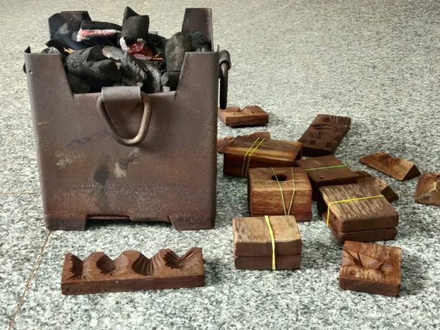 A traditional stove and wooden moulds used to prepare Sakkare Acchu