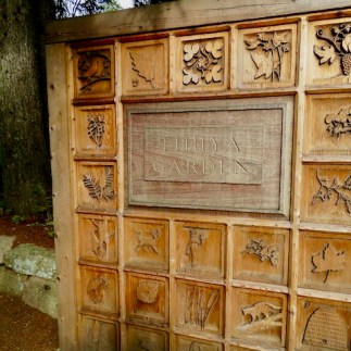 A carved doorway to the Thuya Gardens