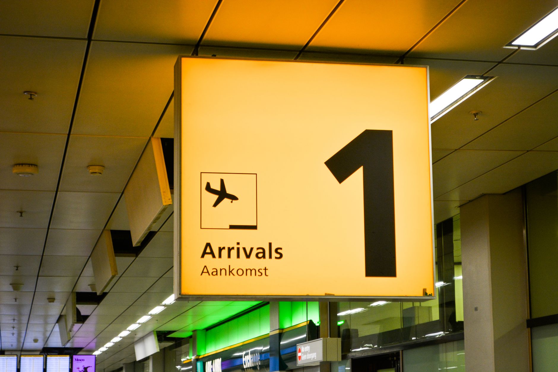 Arrivals hall telecom counter at an international airport where travelers can get help with a SIM or eSIM