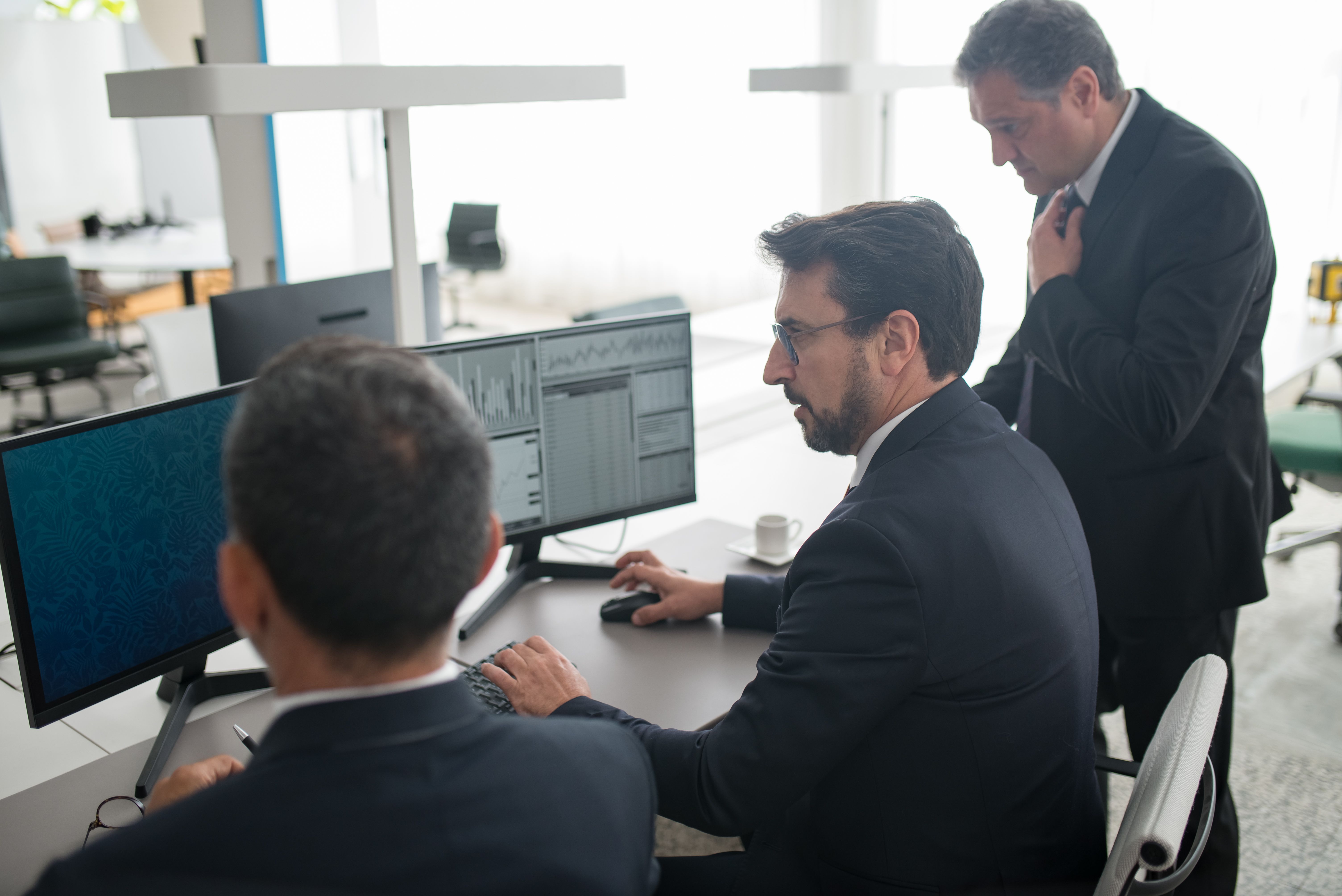 IT professionals reviewing systems at workstations — RDI Solutions managed IT services