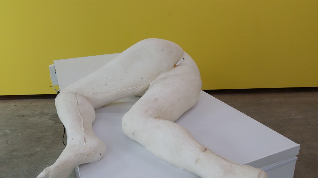 Sculpture with a cigarette in its arse