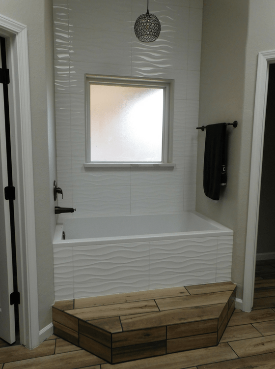 New alcove bathtub, complete with tiles, lighting, and a step