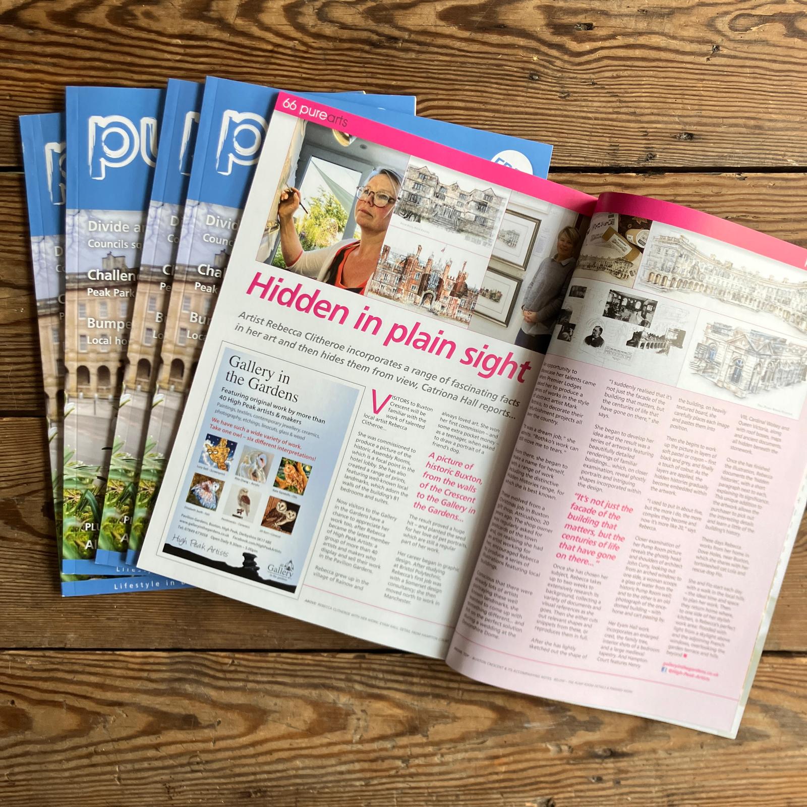 The image shows a spread from the "Pure Arts" magazine. The focus is on an article titled "Hidden in Plain Sight," featuring an artist named Rebecca Clitheroe. The artist is depicted working with her artwork, which includes intricate drawings of buildings and landscapes. The page highlights her unique approach of incorporating hidden facts into her pieces. The magazine cover is visible in the background, and additional pages of the magazine are stacked beneath the open spread.