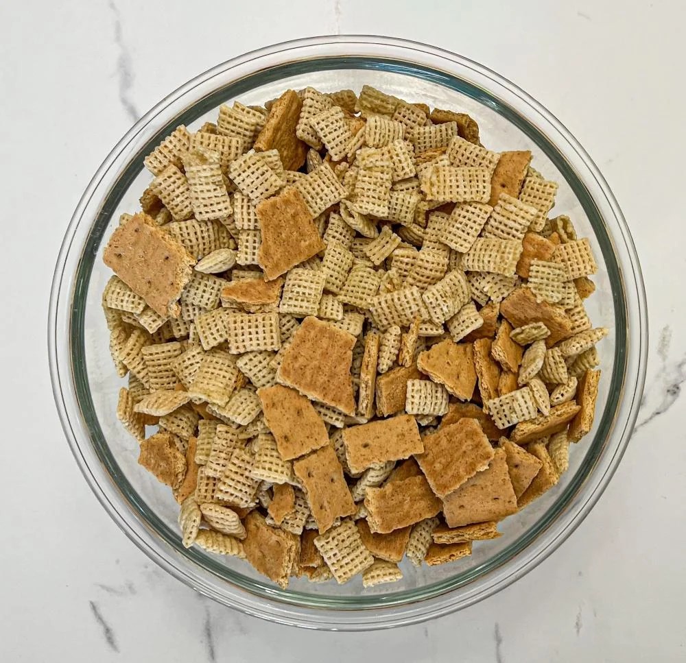 Mixing chex cereal and broken graham crackers