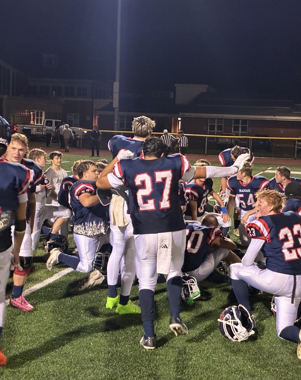 Sophomore Aryan Kheti (27) celebrates postgame with his teammates after Mahar football won its first game of the season on Friday night.