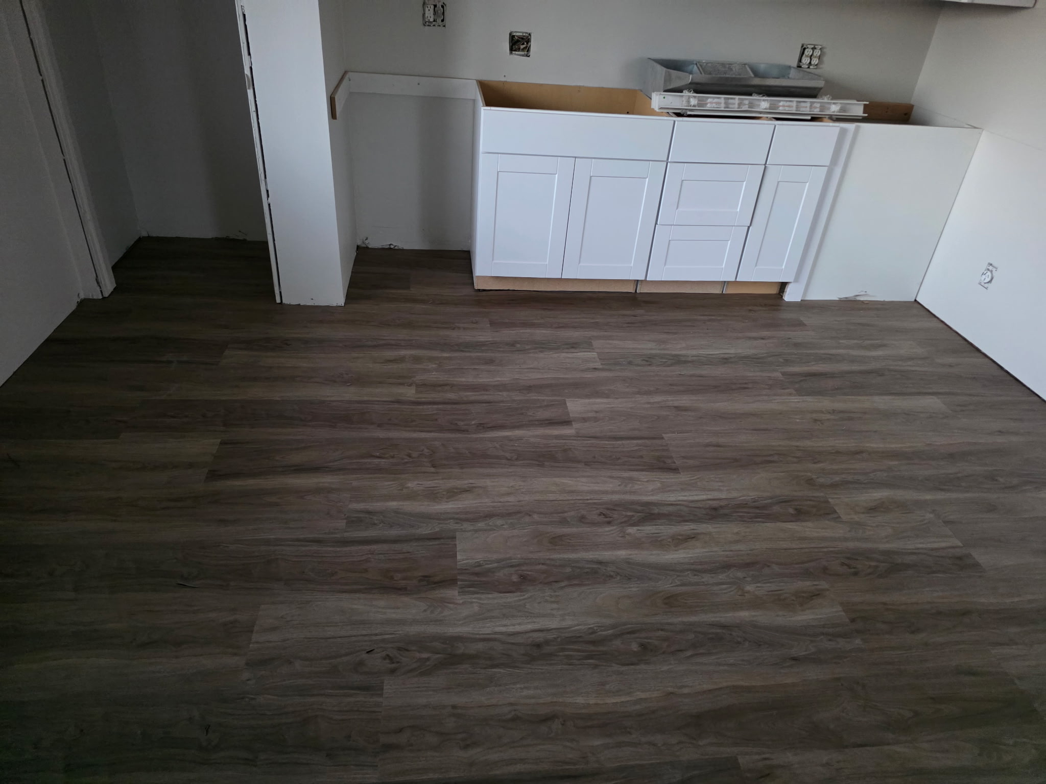 LVP flooring and white kitchen cabinets