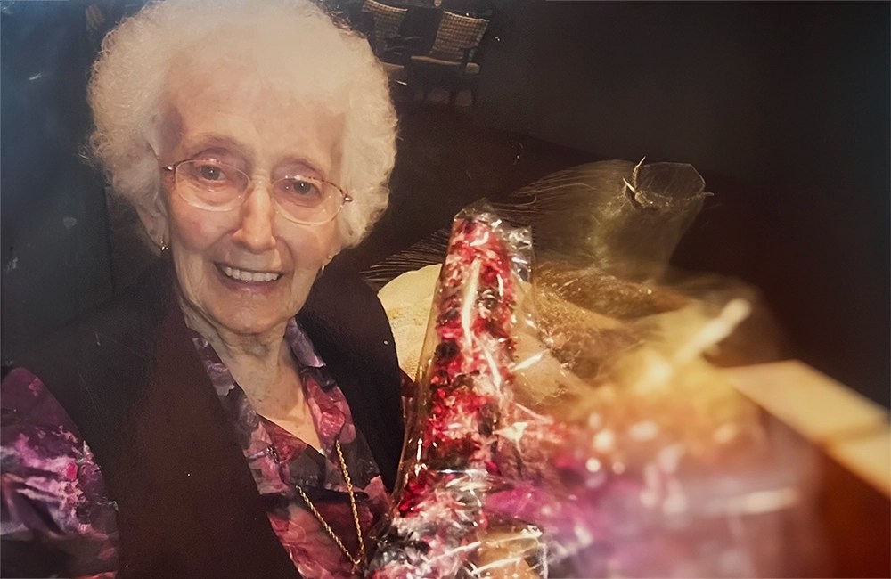 Grandmother holding pink flowers