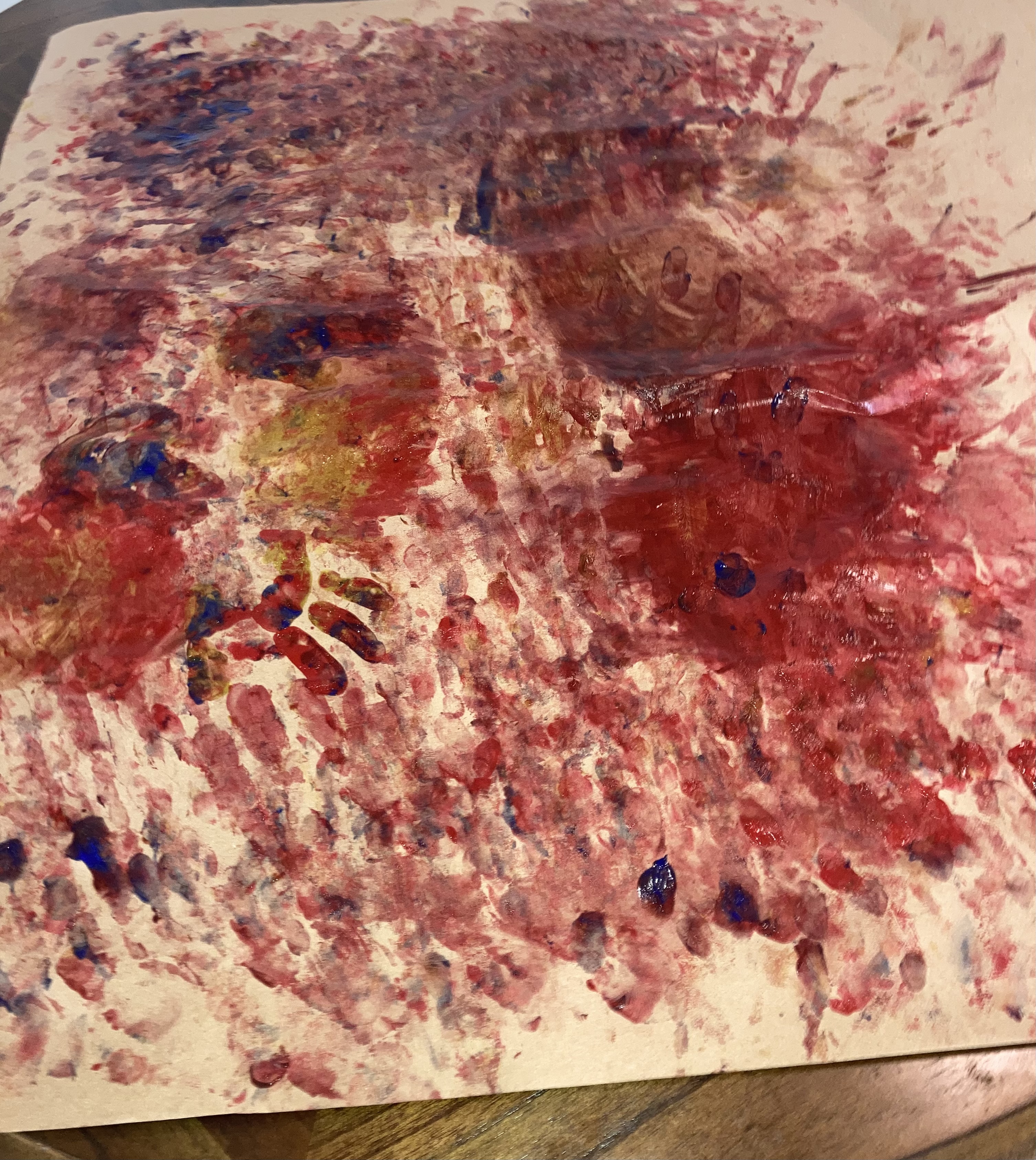 Fingerpainting masterpiece on a roll of wrapping paper.