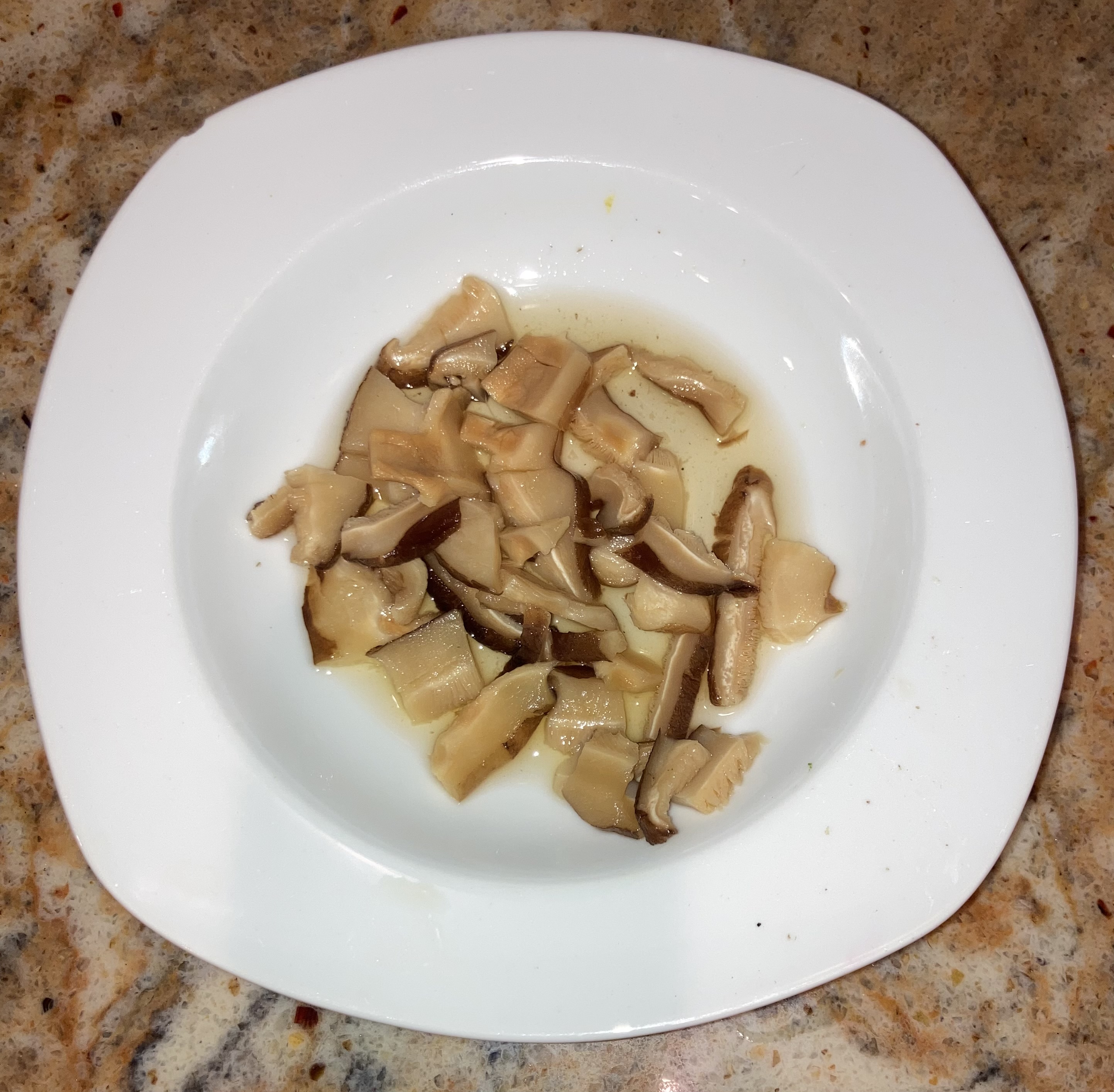 Cut up shiitake mushroom after rehydrating. To be added to miso soup.