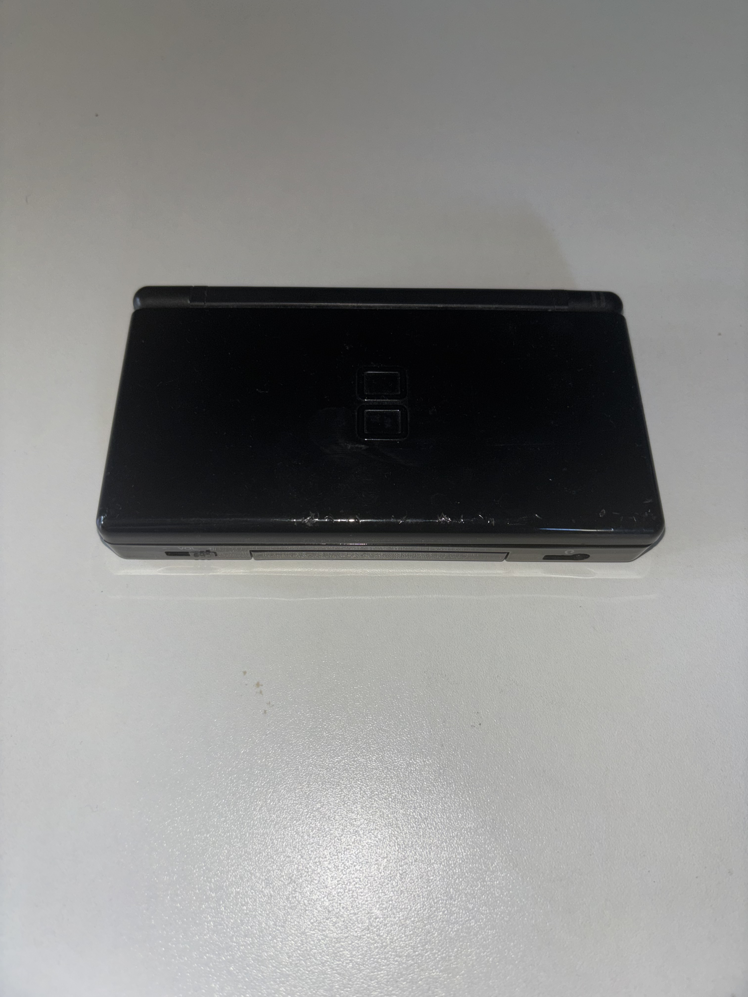 Nintendo DS Lite Black, Model No. USG-001, Released 2006. Owned from 2006- Present. Image taken by Luke Coleman.