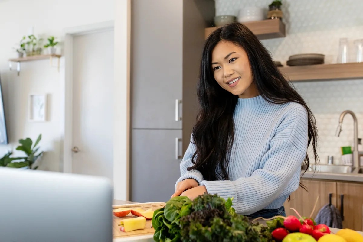The best remote jobs for introverts: Virtual cooking class through laptop in kitchen