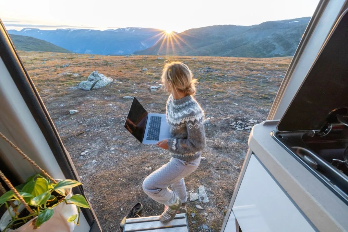 A person traveling the world while working remotely and volunteering