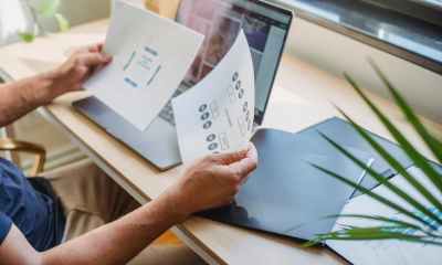 crop man with documents and laptop at table