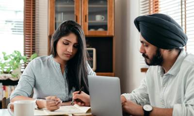 concentrated coworking couple discussing project together