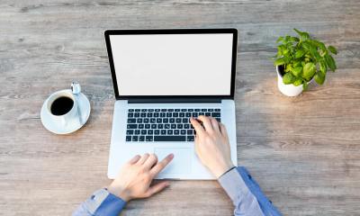 person s hand on laptop