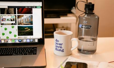 white ceramic mug beside macbook pro