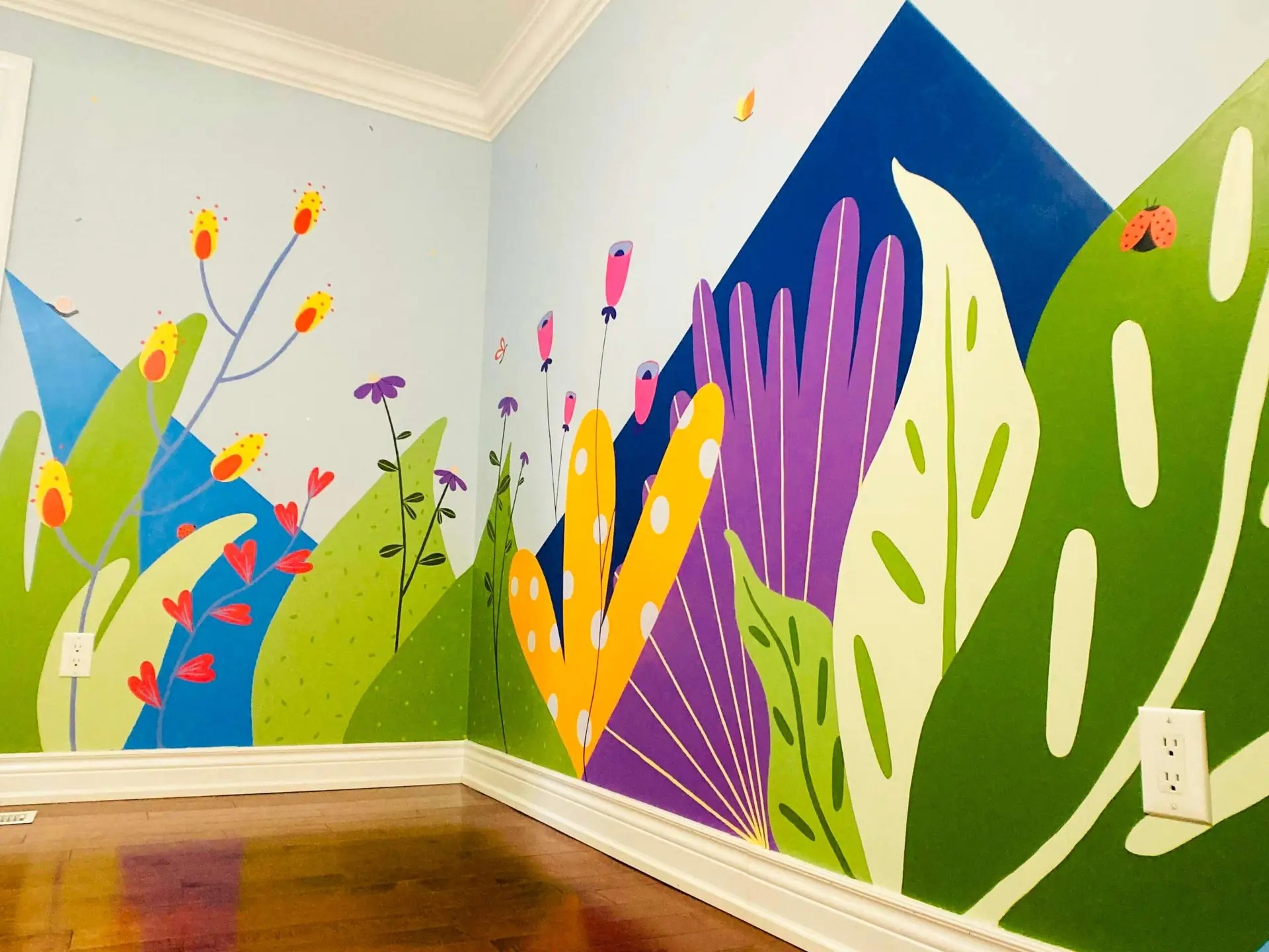 Corner wall mural of colourful flowers and botanical elements with a geometric background.