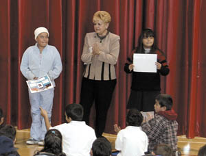 Principal Aida Tadeo encourages a round of applause for these students of the month.