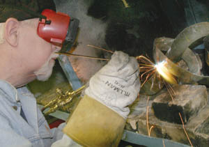 David Luke welds an abstract piece of steel art in the Advanced Welding and Art class offered by TMCC at Reed High School.