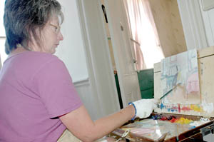 Artist Leigh Anne Boi of Carson City paints in one of the quiet rooms available during St. Mary’s Open Studio Tuesdays.