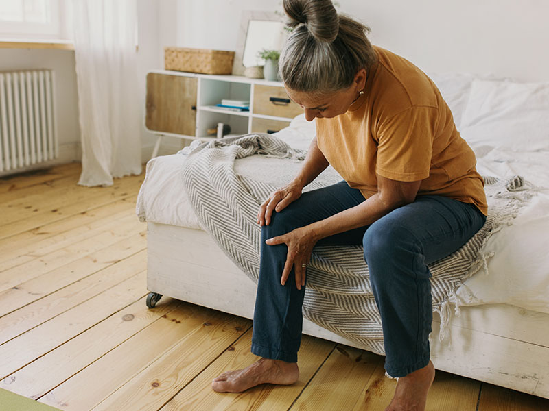 Mature woman bracing knee