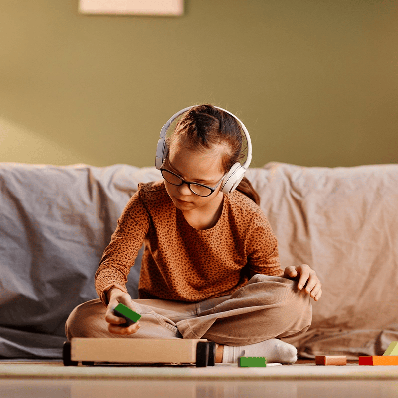 Neurodivergent child playing with headphones on