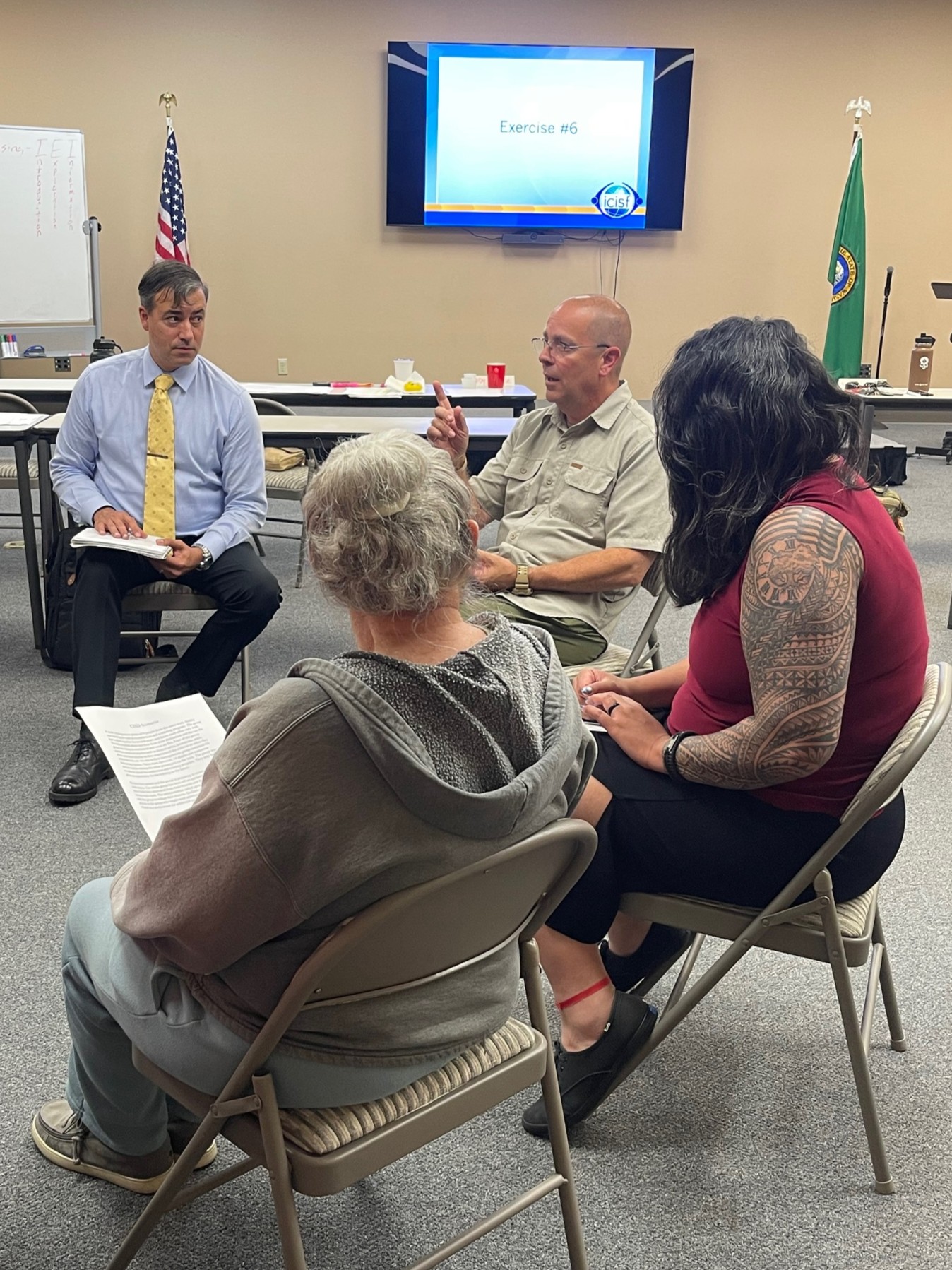 An instructor leads a small-group discussion during a CISM class