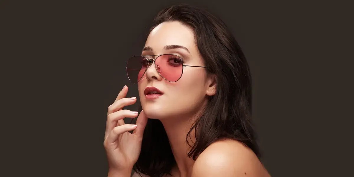Portrait of a woman wearing pink sunglasses, professionally retouched for high-end eCommerce presentation.