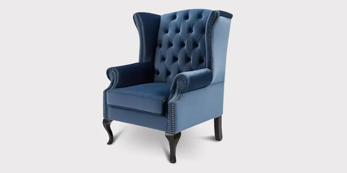 Blue upholstered armchair isolated with professional furniture photo editing.
