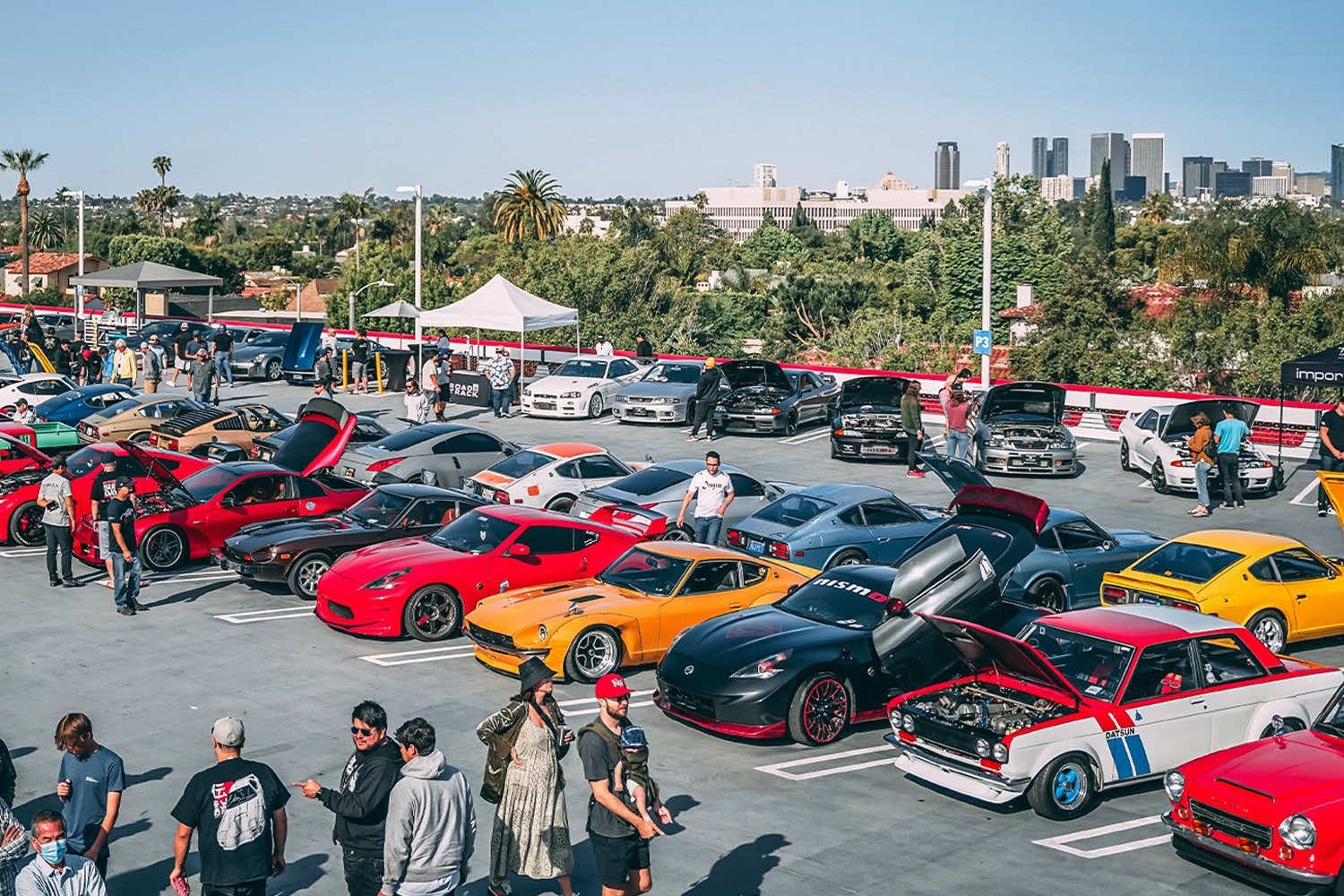 Enthusiasts in car meet outfits at a JDM car show