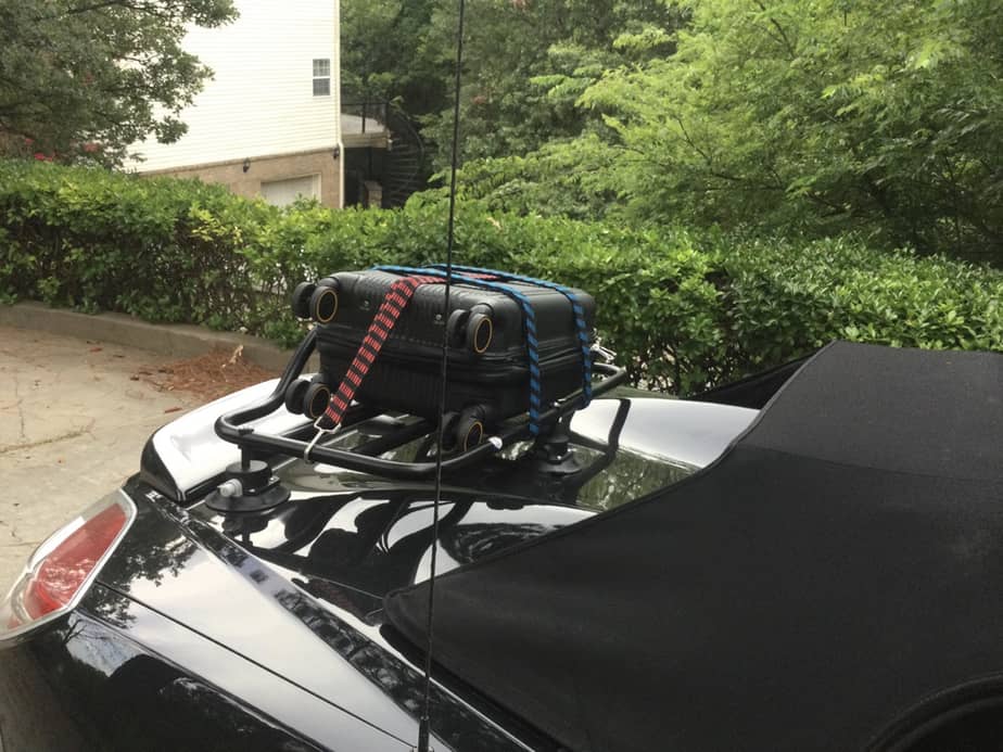 black saturn sky with a luggage rack fitted carrying a black suitcase