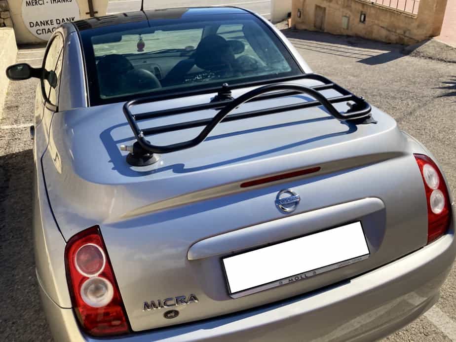 Nissan Micra with black revo rack luggage rack attached on a sunny day
