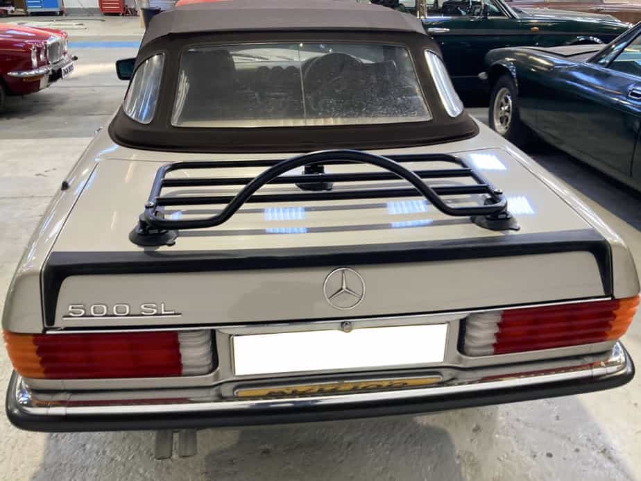 silver mercedes benz sl 500 with a foam rear spoiler and a a black luggage rack fitted