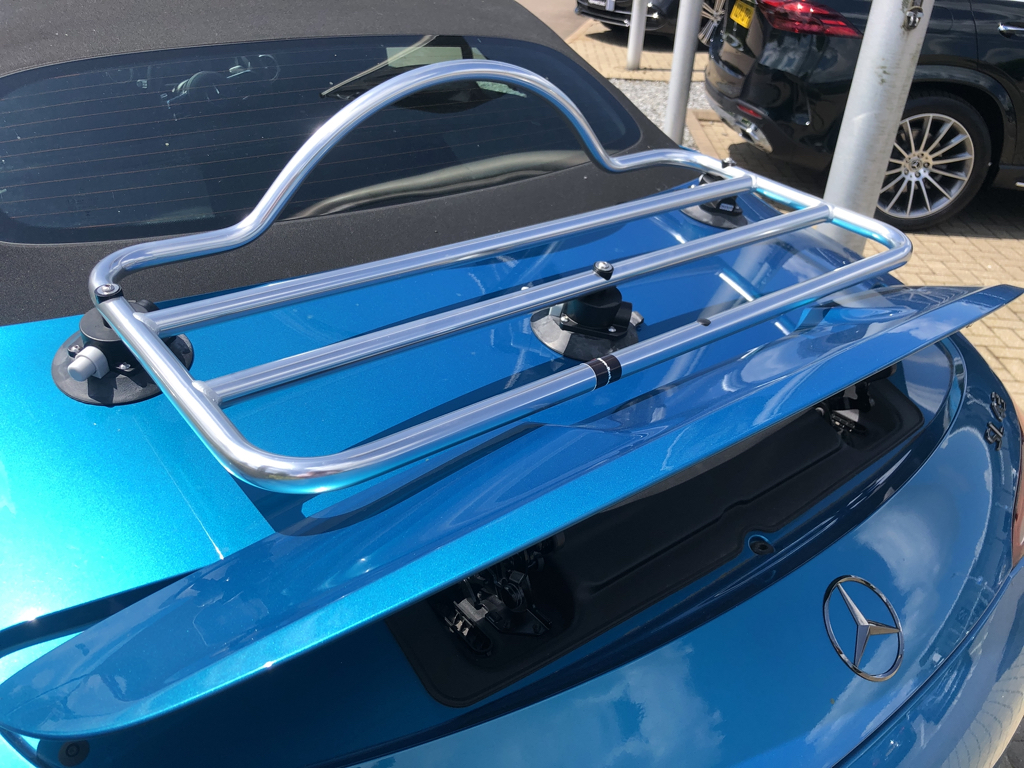 rear photo of a turquoise mercedes benz sl 43 AMG R232 with a luggage rack fitted to the trunk lid
