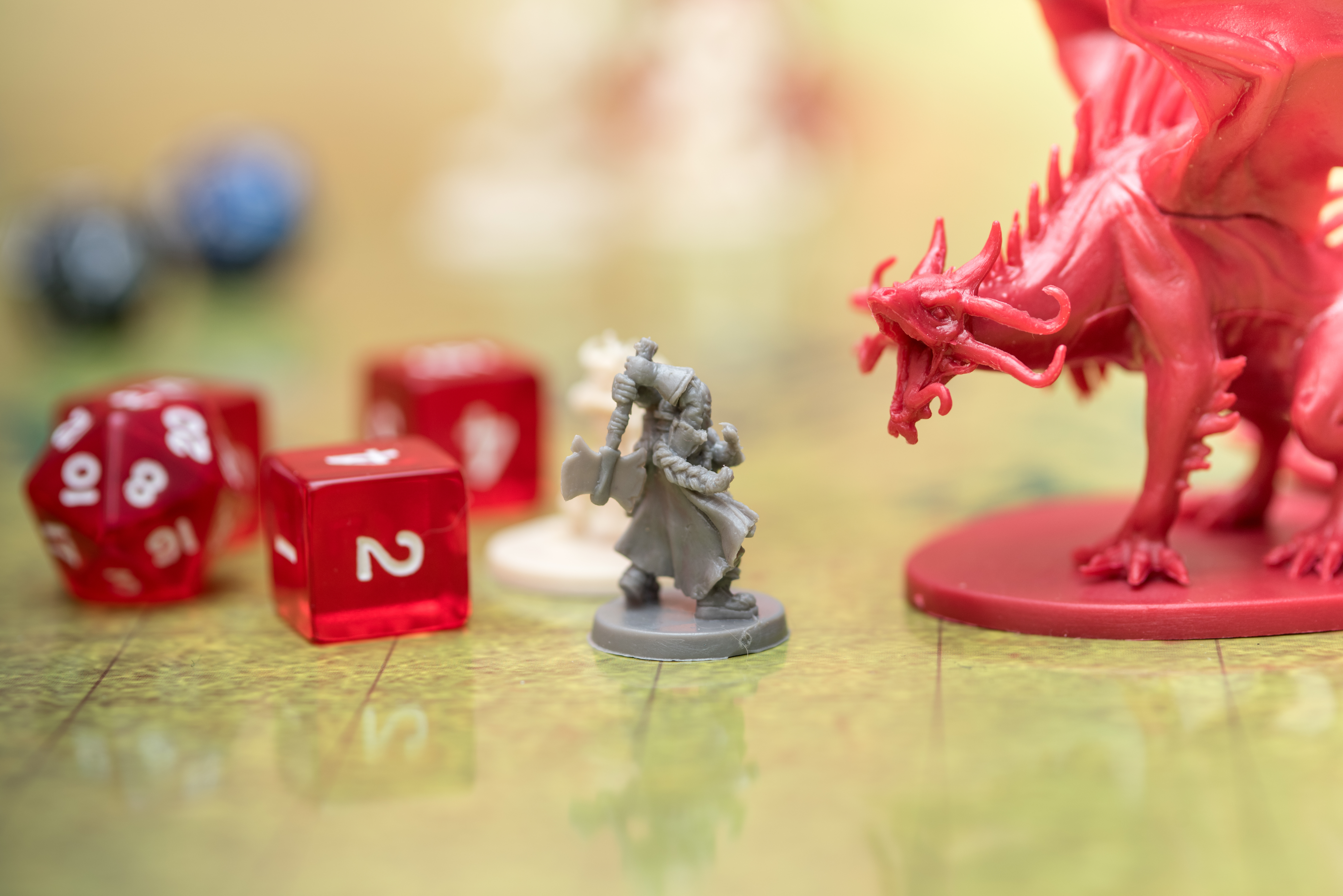 Detail of two miniatures fighting on the battlefield of the role-playing game of dungeons and dragons. Game dices next to the figures.