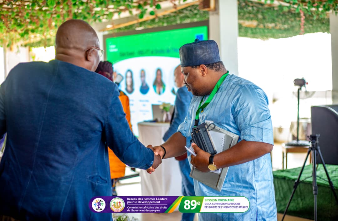 Participants greet each other during a break in the programme.