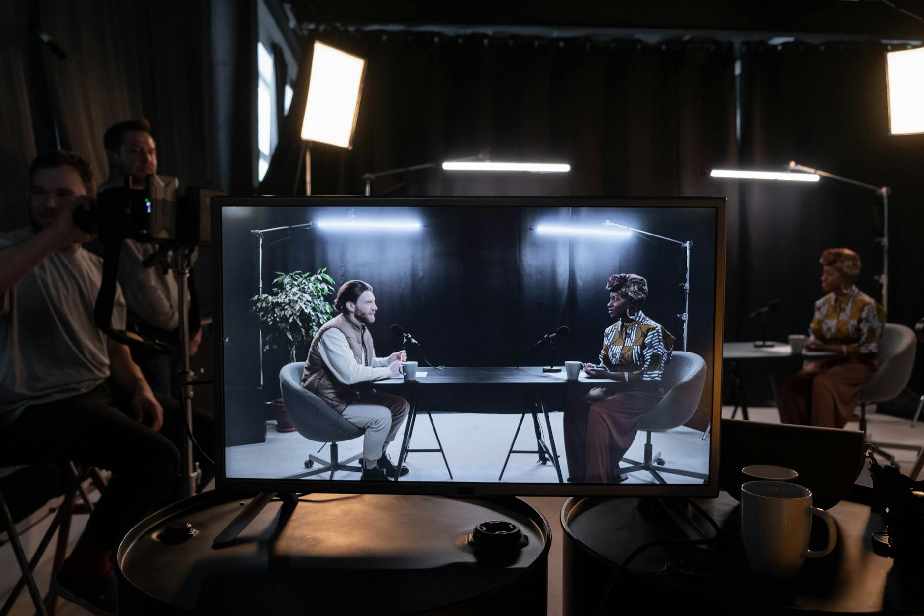 woman and man on tv screen at studio
