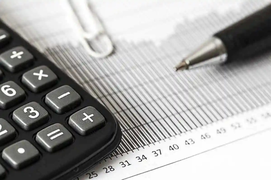 Calculator and Pen on Table