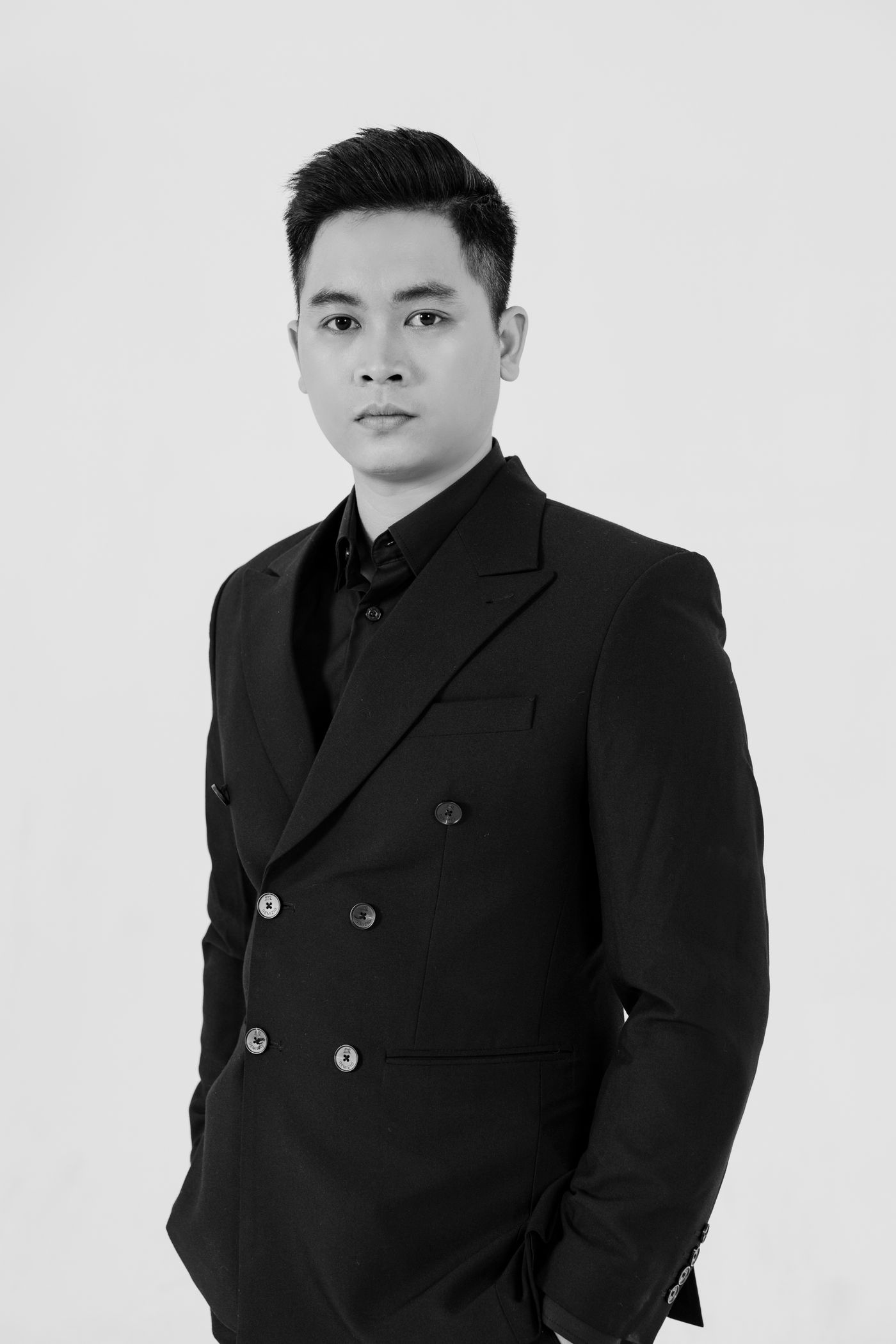 Black-and-white portrait of a man wearing a tailored suit