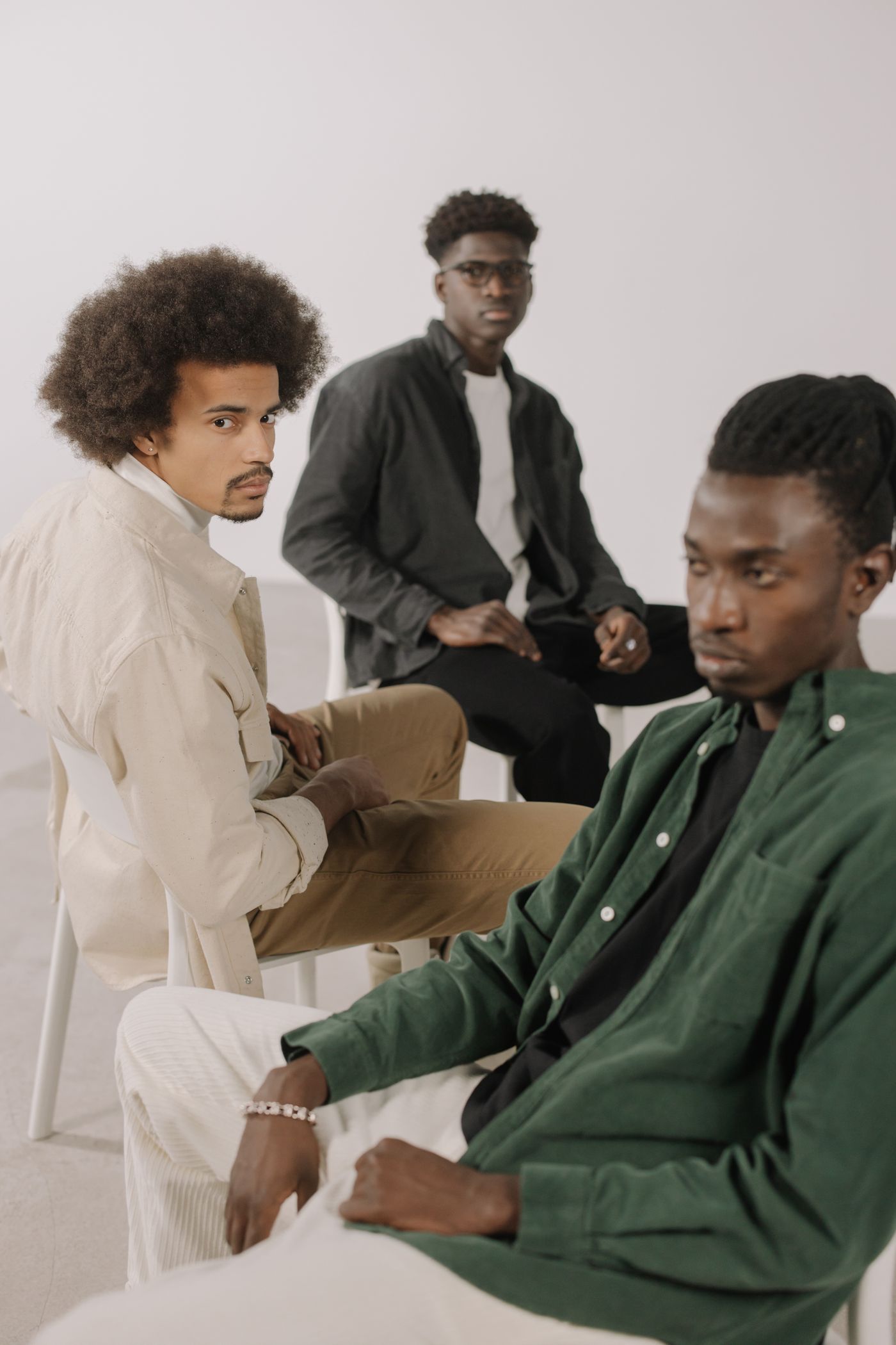 Three stylish men photographed together in the studio
