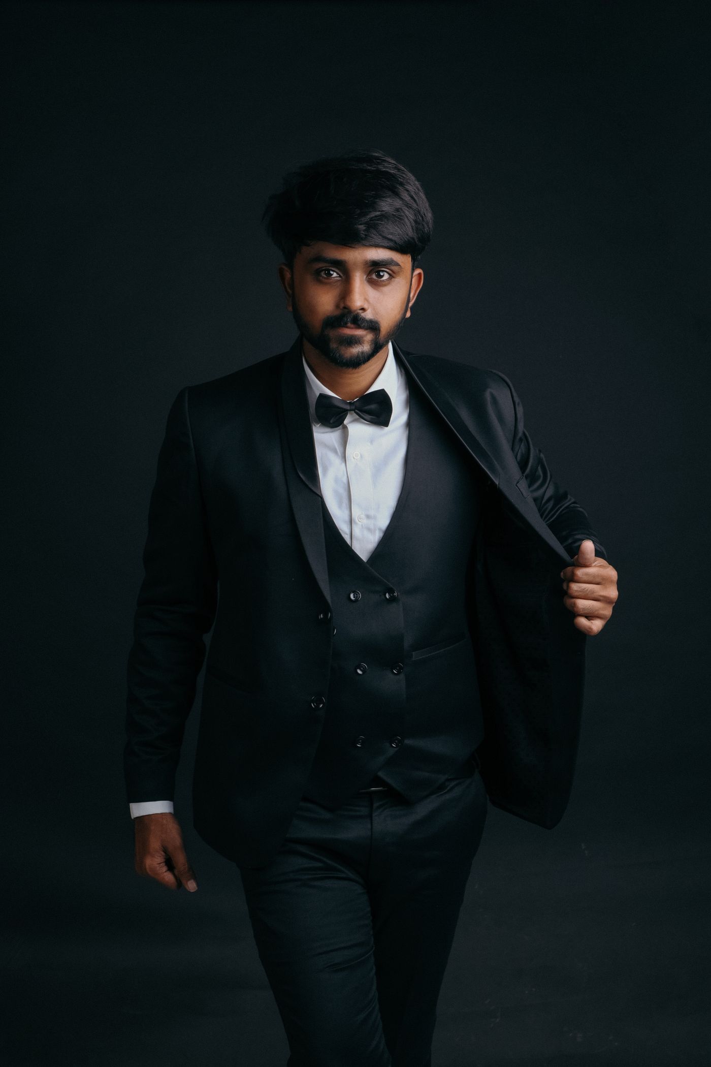 Editorial portrait of a man wearing a full tailored suit