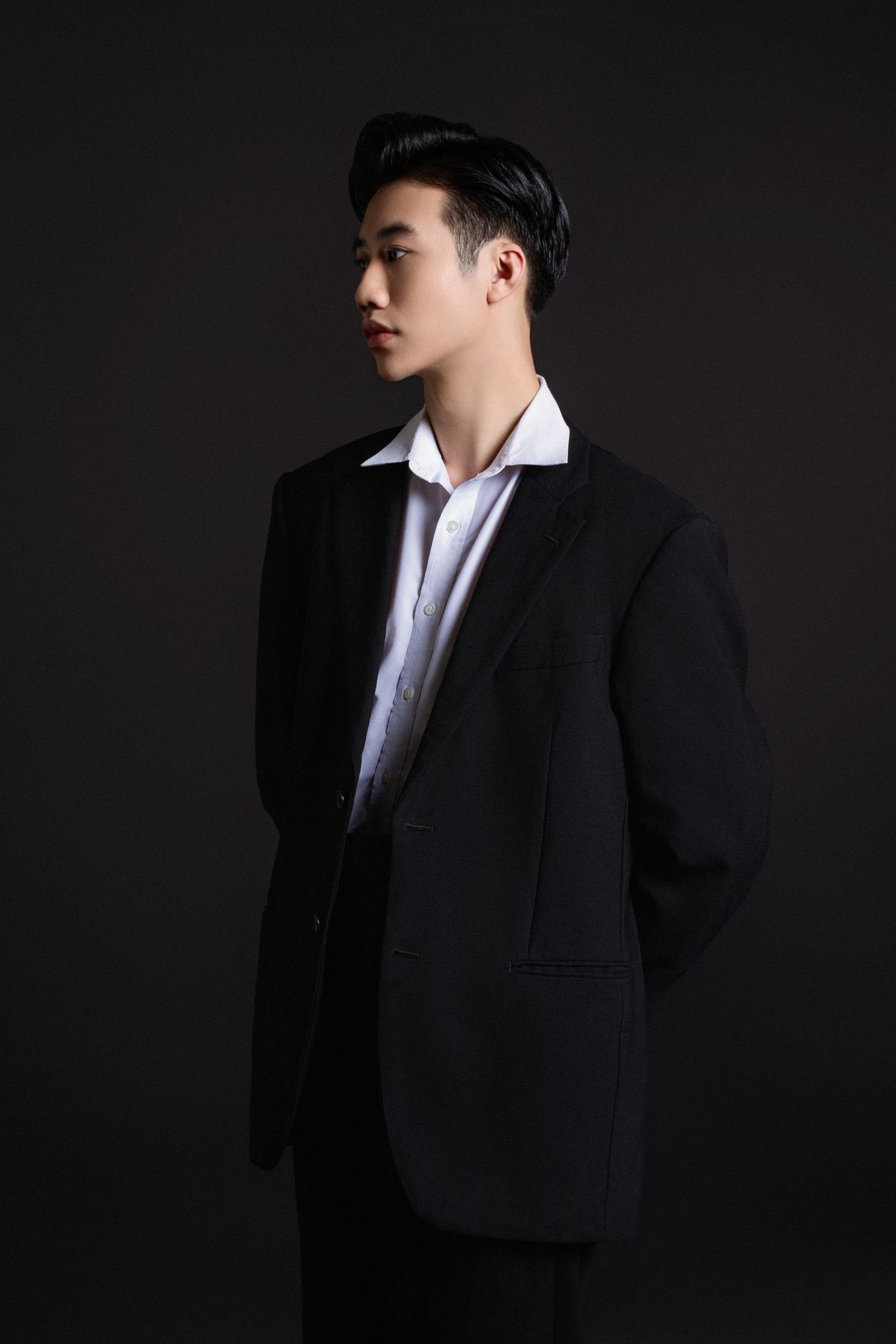 Elegant studio portrait of a man in a dark suit