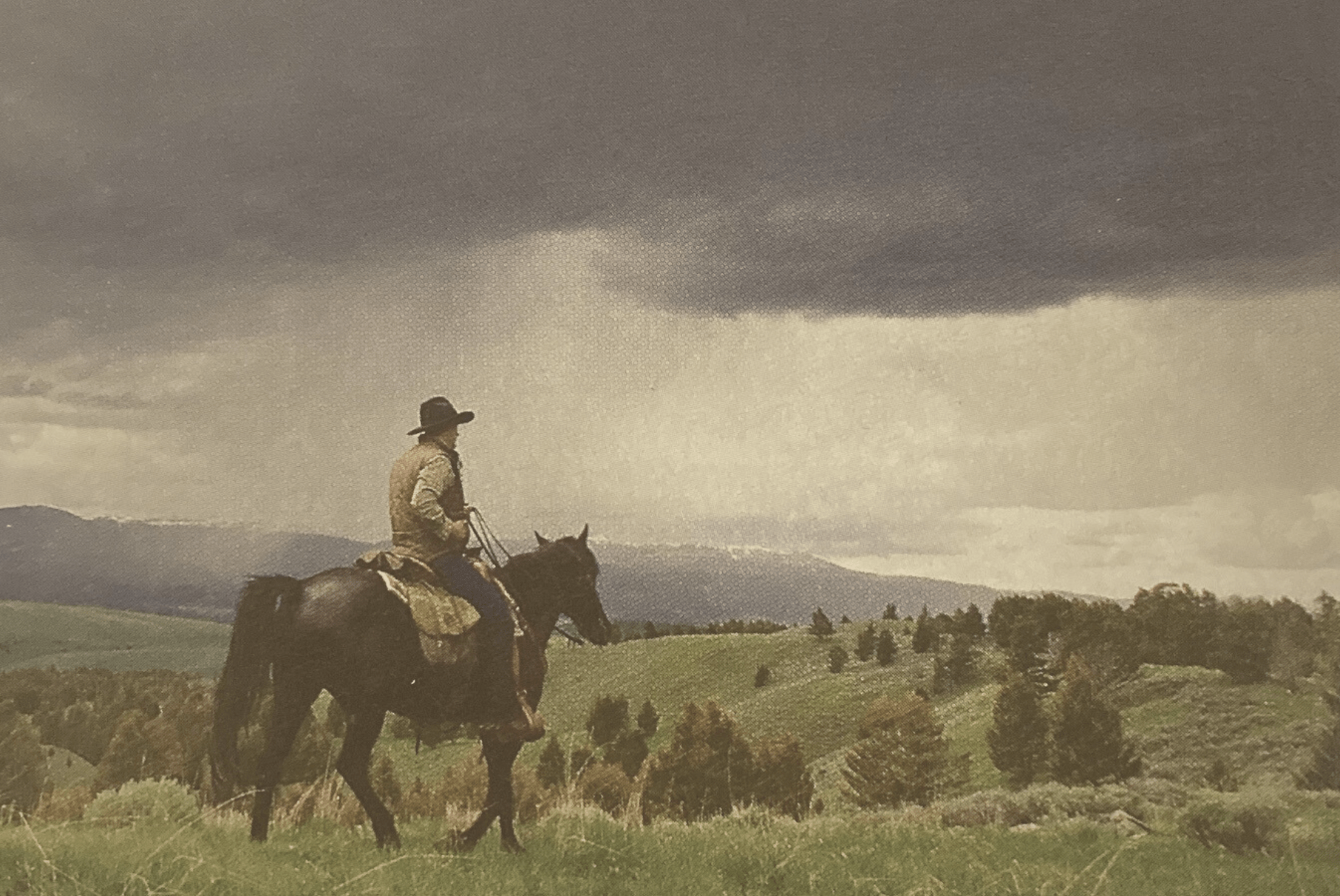 Lone cowboy riding in a rainstorm representing living the cowboy code