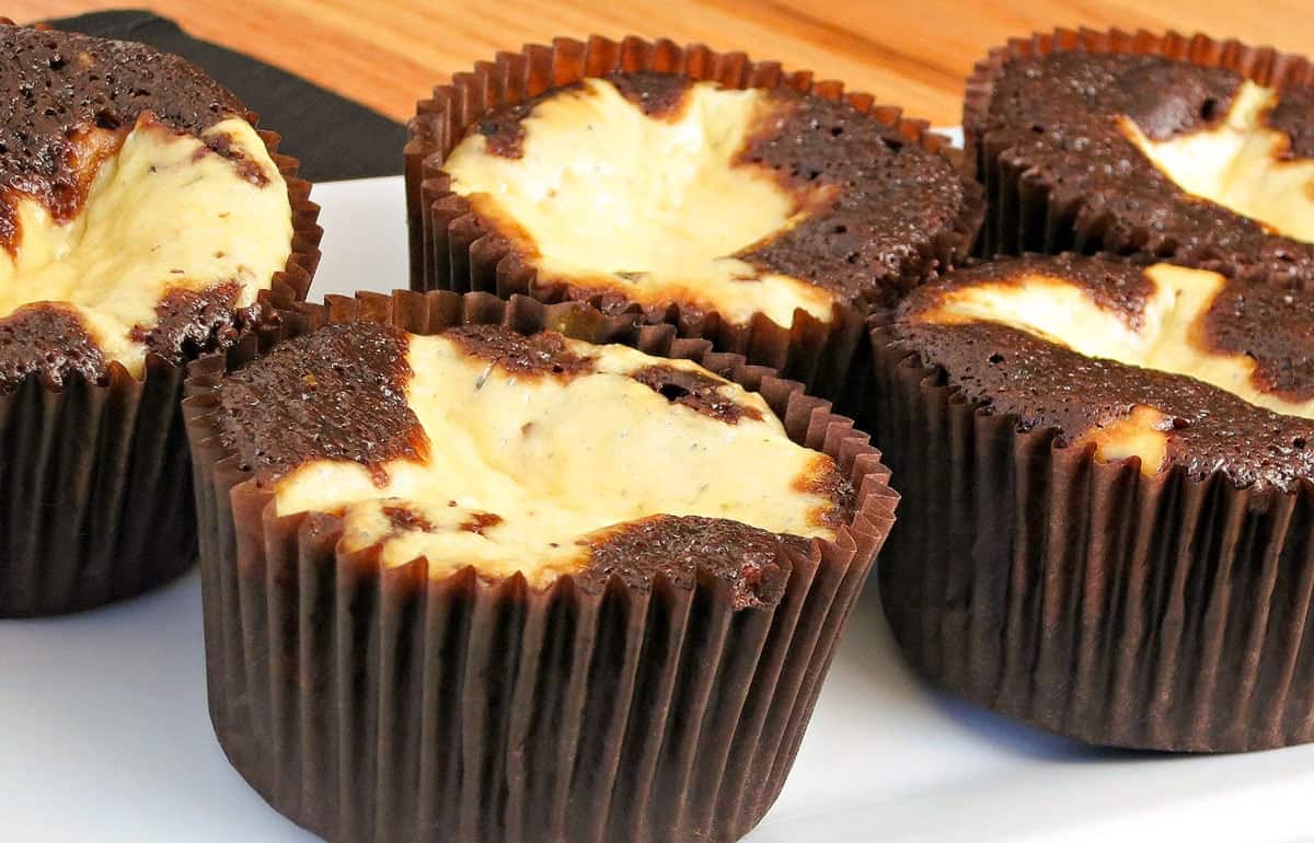 plate of cupcakes on a wooden countertop