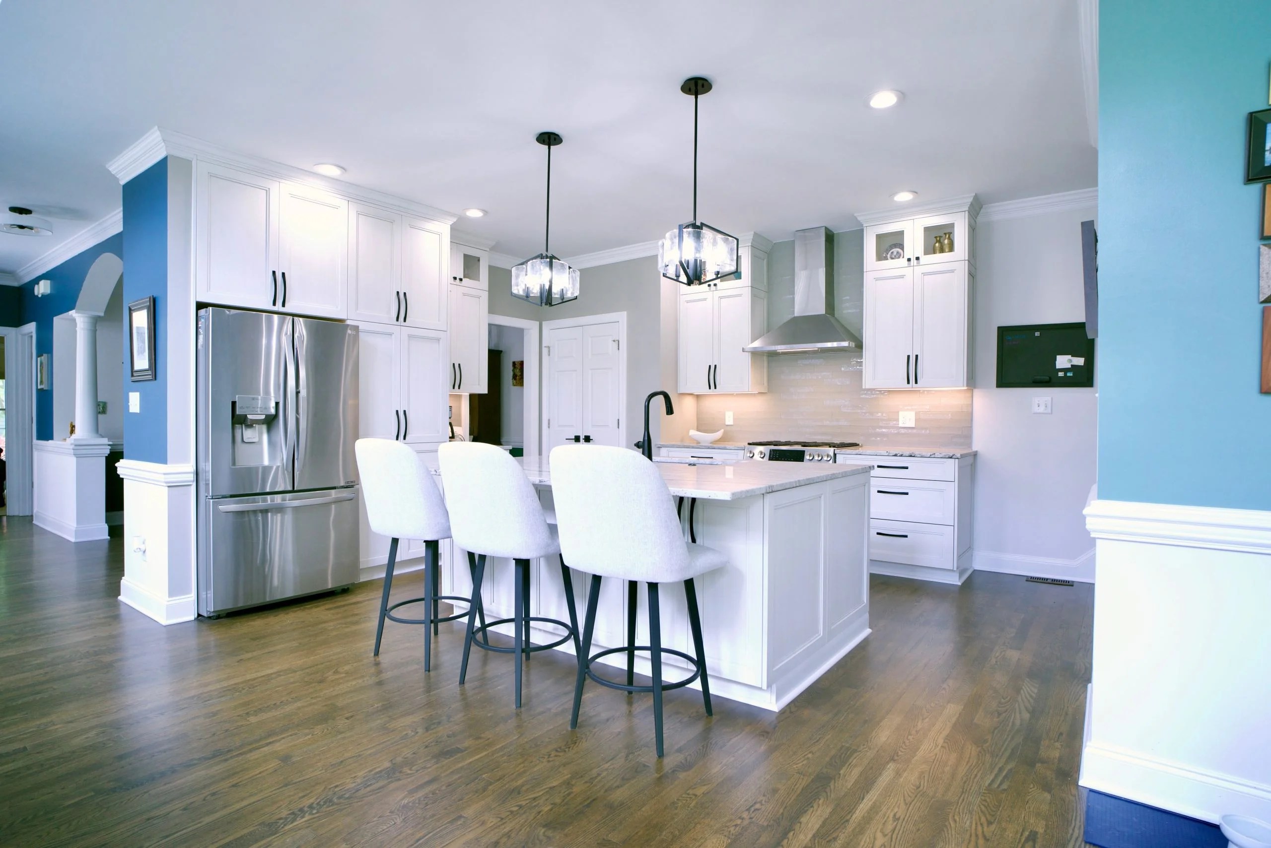 Open kitchen with 2 large glass pendant lights